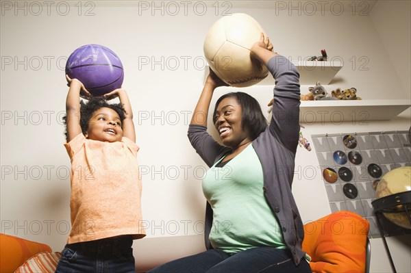 African American mother and son throwing balls