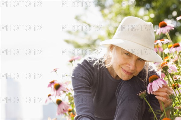 Smiling Caucasian woman holding flower