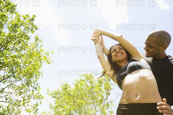 Smiling couple stretching outdoors