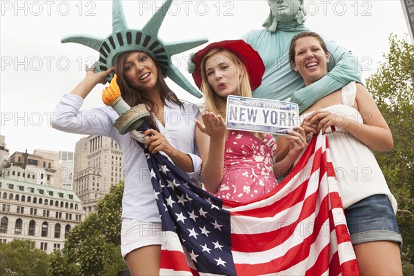 Laughing friends visiting the Statue of Liberty