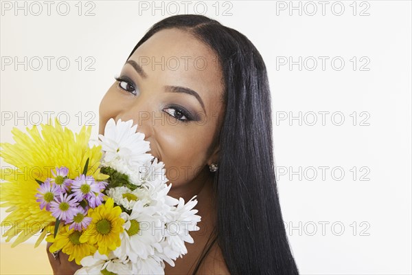 Black woman holding bouquet of flowers