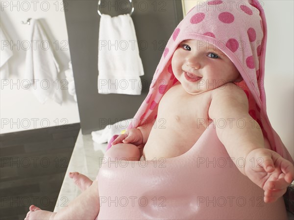 Caucasian baby girl siting in high chair