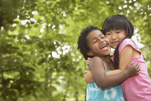 Girls hugging outdoors