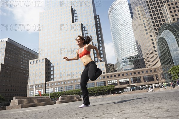 Mixed race woman working out on city street