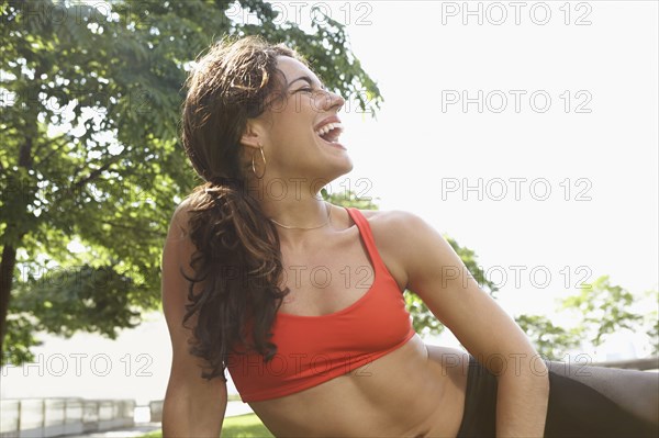 Mixed race woman laughing outdoors