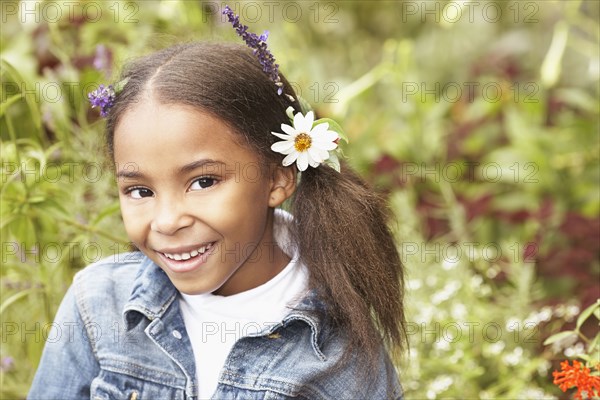 Mixed race girl wearing flowers in her hair