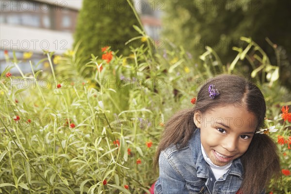 Mixed race girl wearing flowers in her hair