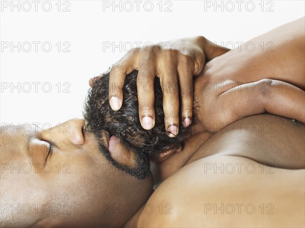 Black father cradling baby