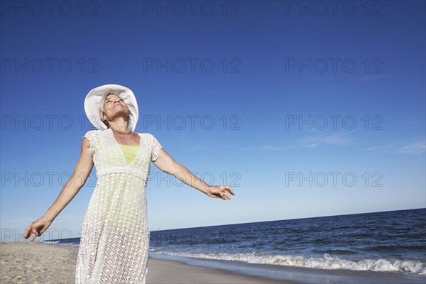 Senior woman standing on tropical beach