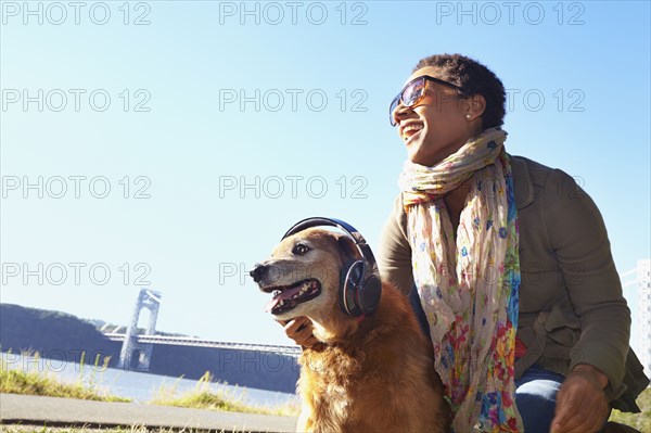 Black woman and dog relaxing in park