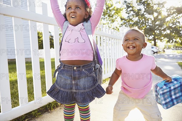 Mixed race girls playing on suburban street