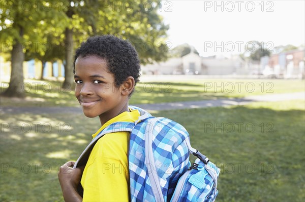 Mixed race boy smiling outdoors