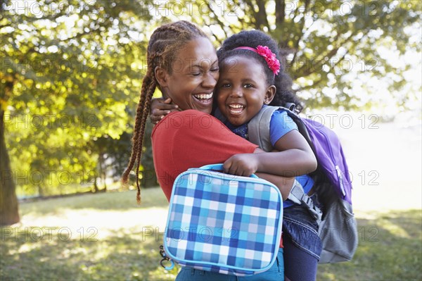 Mixed race mother and hugging daughter