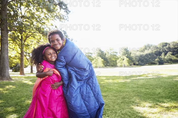 Mixed race children wrapped in sleeping bags