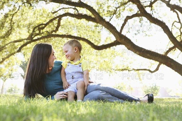 Caucasian mother and son relaxing in park