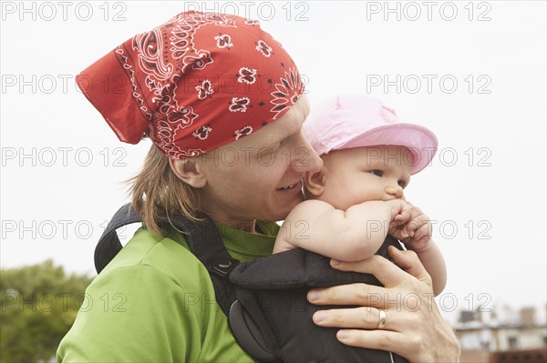 Father carrying baby outdoors