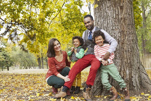 Family smiling together in park