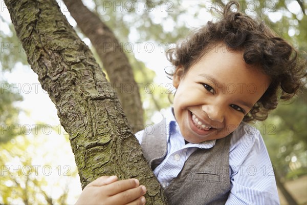 Mixed race boy smiling in park