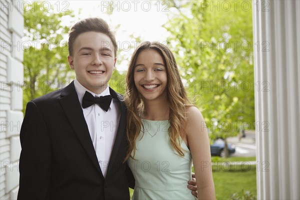 Smiling teenage couple dressed up for prom