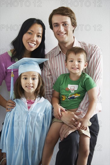 Family with graduating daughter smiling together