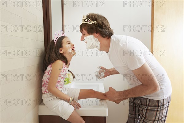 Father and daughter playing in bathroom