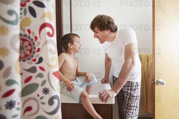 Father and son talking in bathroom