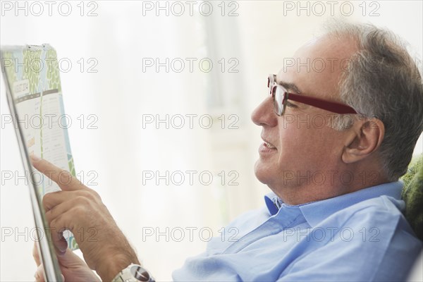 Hispanic man reading map
