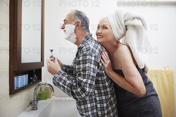Older couple getting ready in bathroom