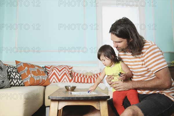 Father and daughter playing in living room