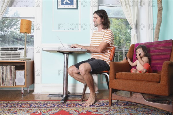 Father and daughter relaxing in living room