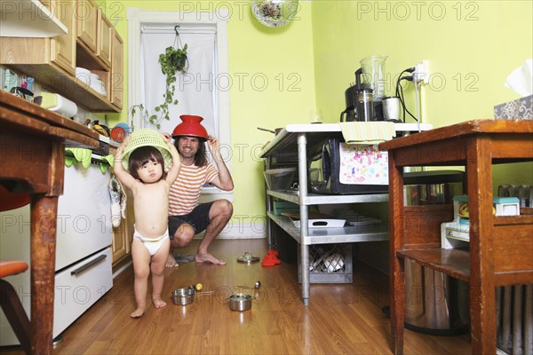Father and daughter playing in kitchen