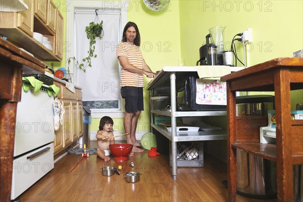 Father and daughter playing in kitchen