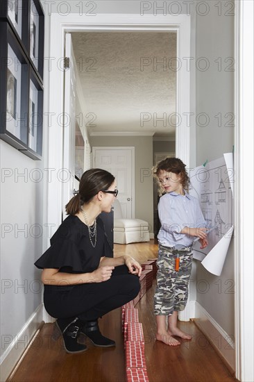 Caucasian mother and daughter talking in hallway