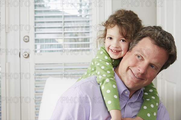 Caucasian man carrying daughter piggyback