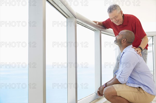 Father and son standing on balcony