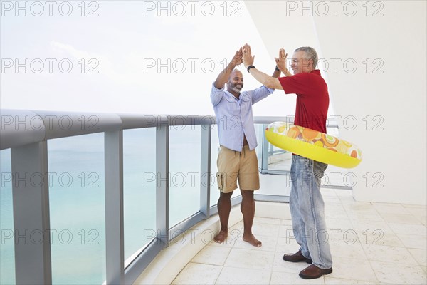 Father and son cheering in inflatable ring