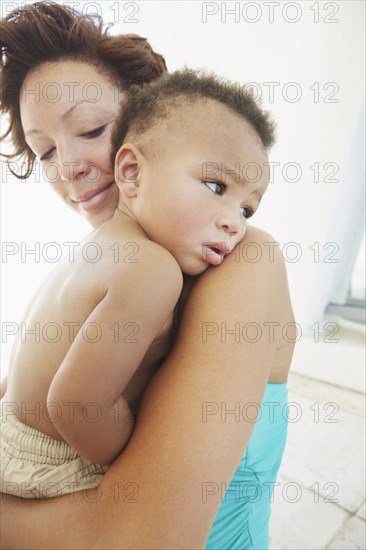 Close up of Black mother comforting son