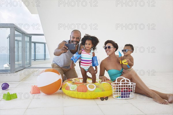 Black family taking selfie with swimming gear