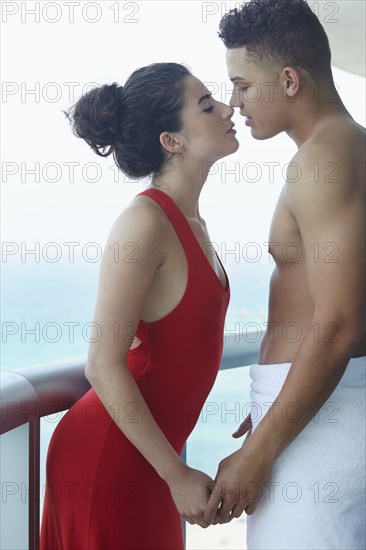 Couple kissing on balcony