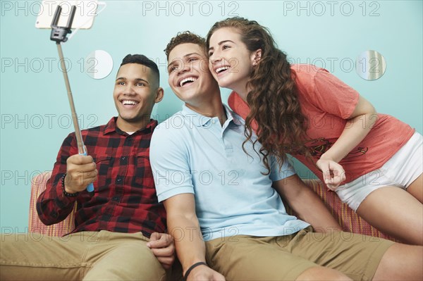 Smiling friends taking selfie together