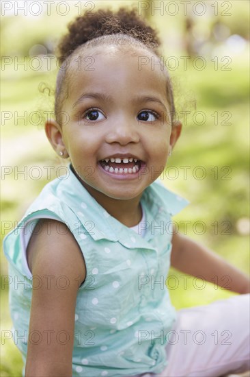 Mixed race girl smiling in park