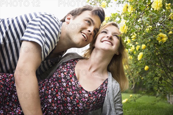 Caucasian couple hugging in garden