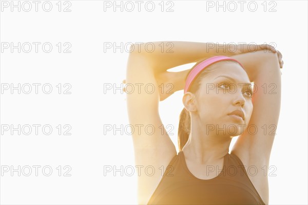 Hispanic woman stretching outdoors