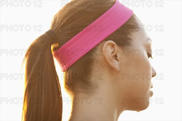 Rear view of sweating Hispanic woman