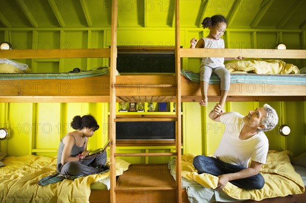 Father and daughters relaxing at camp