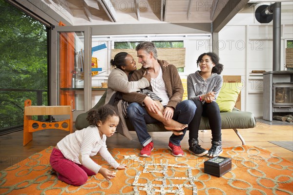 Family hugging in living room