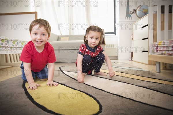 Children playing on floor in bedroom