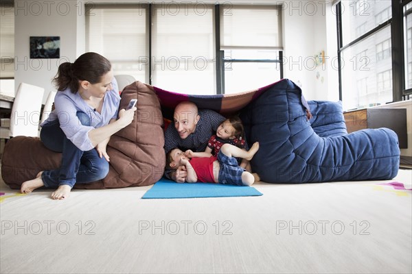 Family playing in blanket fort