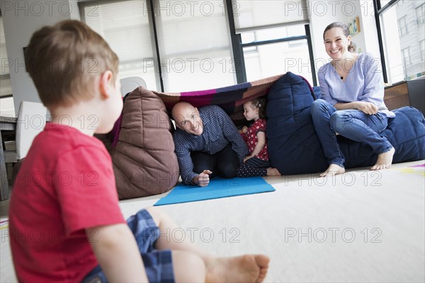 Family playing in blanket fort