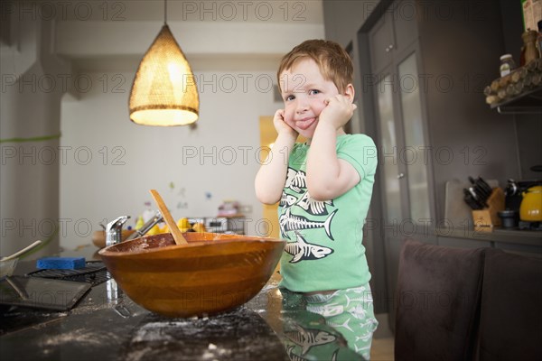 Boy cooking in kitchen